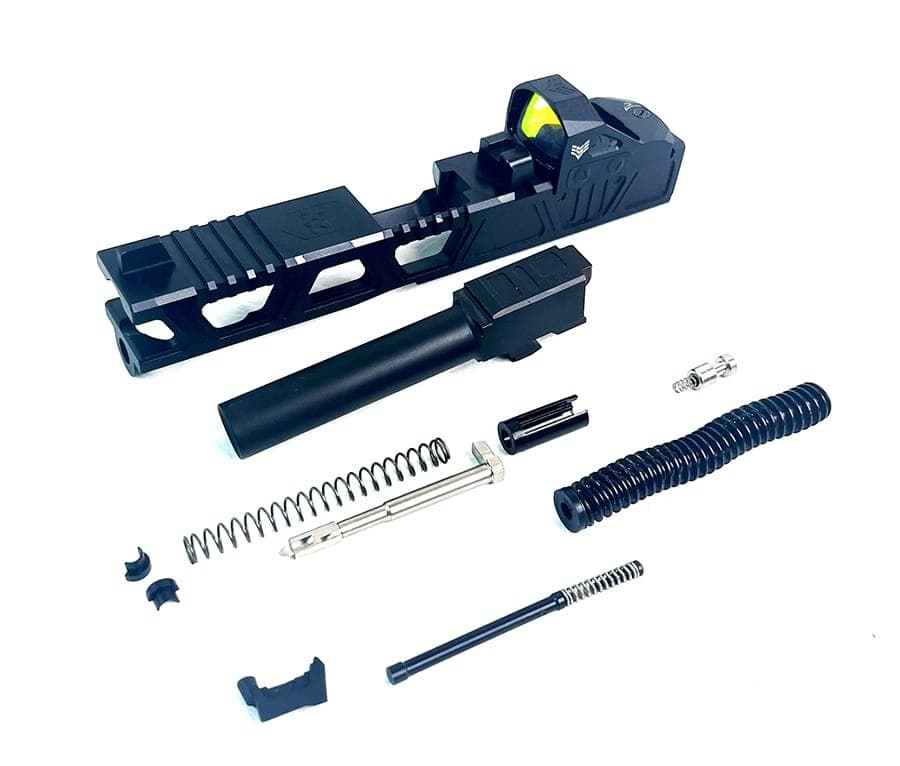 Glock slide and upper parts laid out for assembly