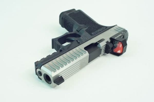 Bead-blasted stainless slide with a red dot on a black frame