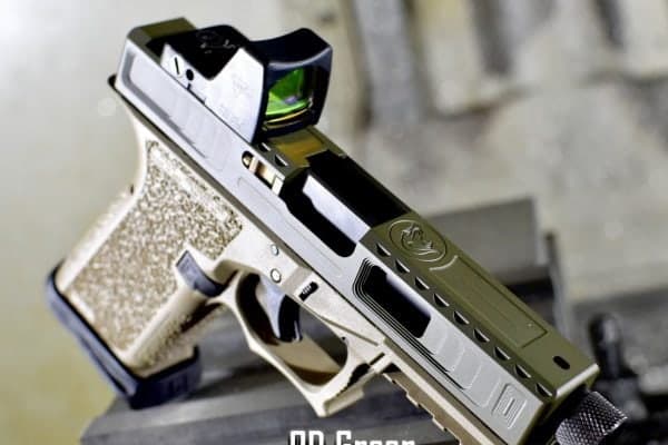 OD green slide with a red dot on a stippled tan frame