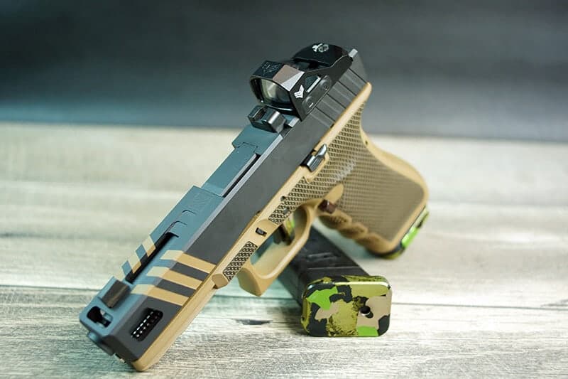 Apprentice slide in sniper grey with FDE stripes and a red dot optic, on an FDE Glock 17 frame