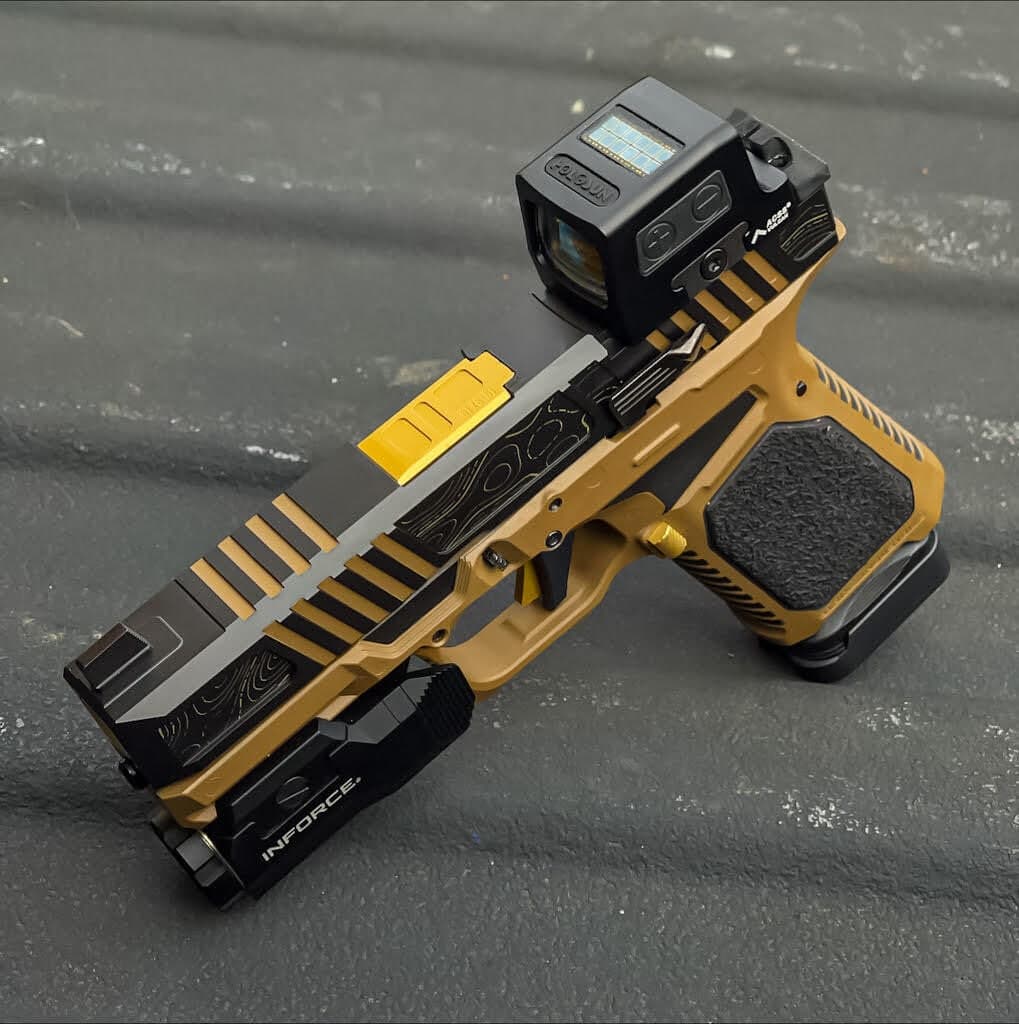 Griffin slide in black with gold-filled serrations, wearing a Holosun 509T enclosed optic
