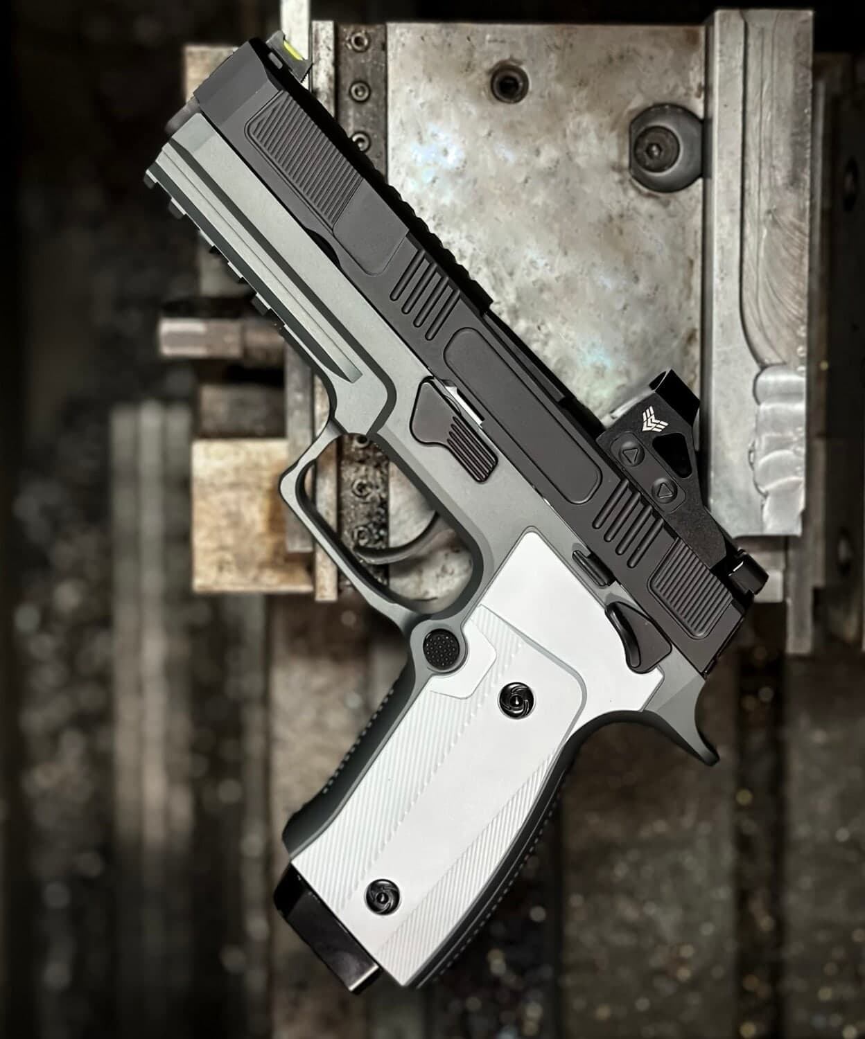 Counter Strike slide in black on a silver P320 grip module, photographed against a weathered dark wall