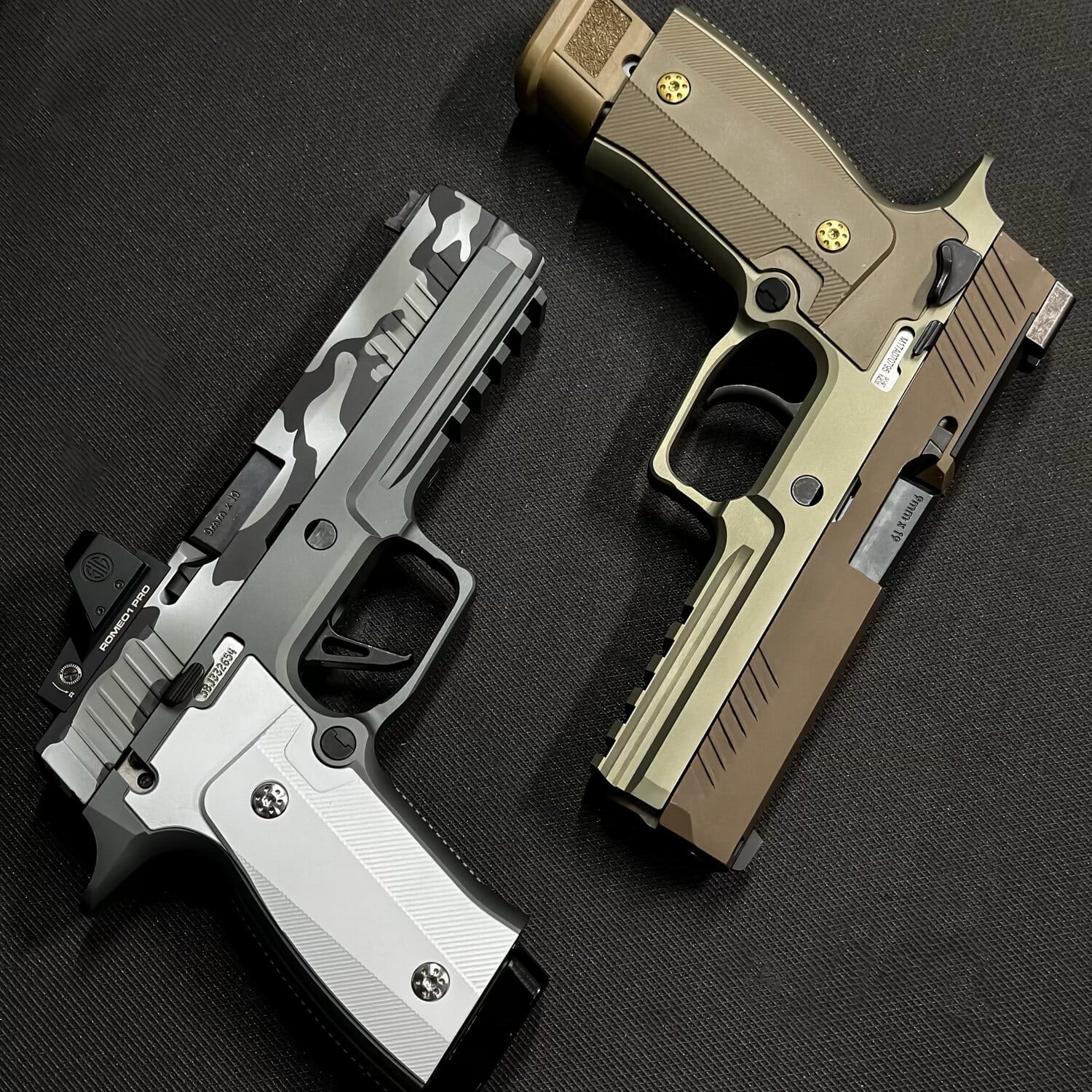Two Sig P320s fitted with FSB-M metal grip modules, one in stainless and one in grey