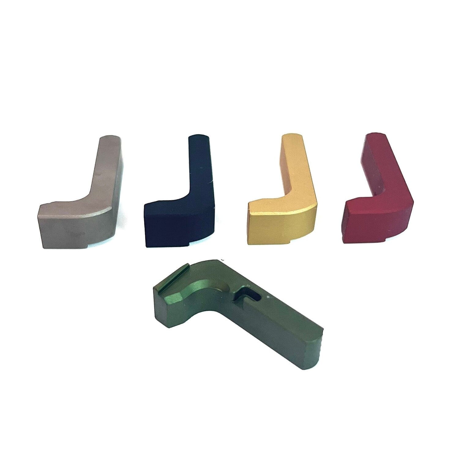 Five minimalist magazine releases in grey, navy, gold, red and green Cerakote, lined up on white