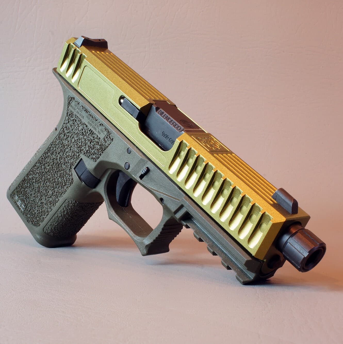 Bulldog slide in gold with full-length angled serrations and a threaded barrel, on an OD green Glock 19 frame